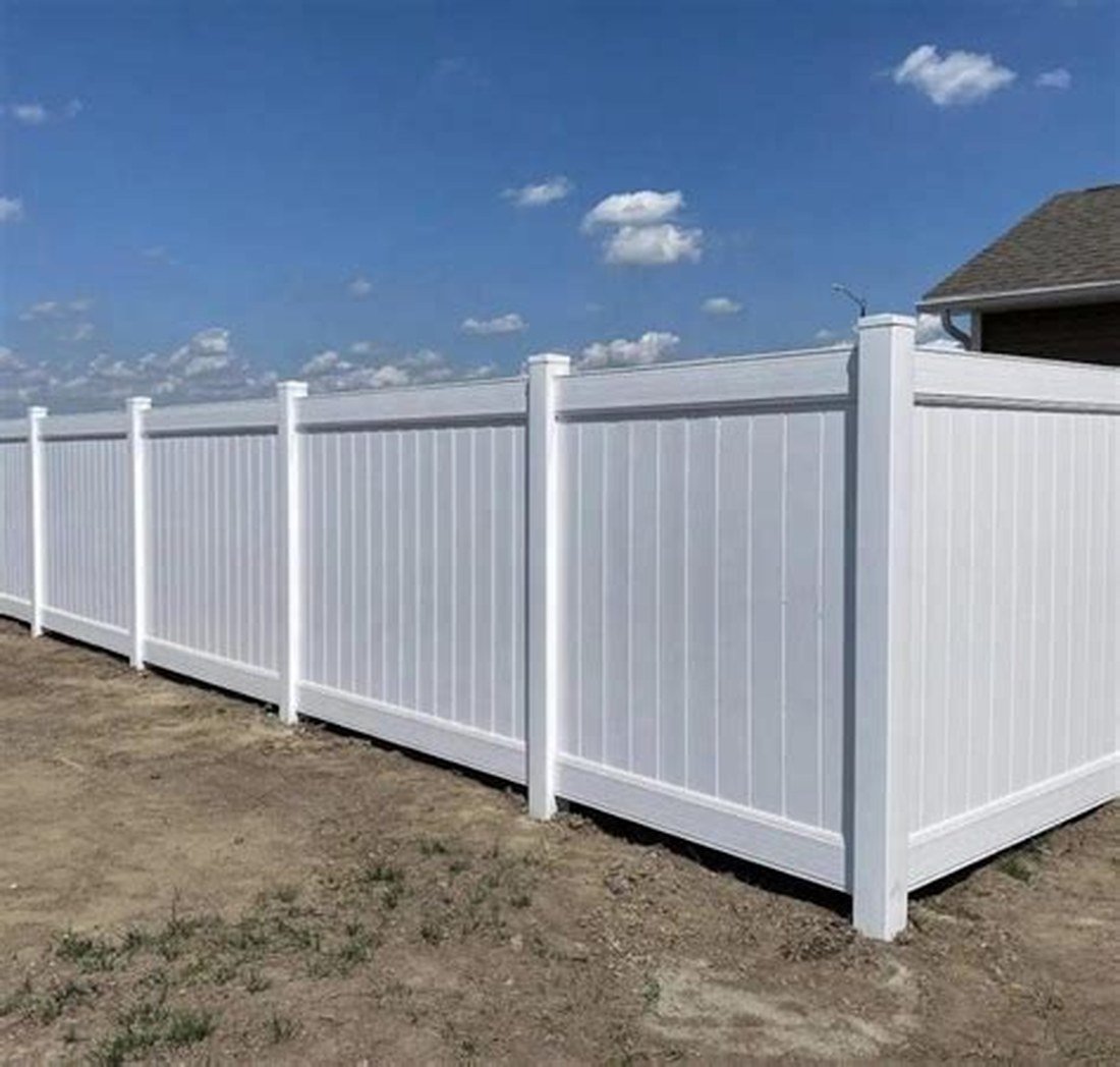 6-foot white PVC privacy fence installed along a property line